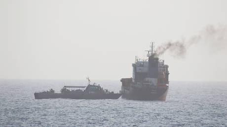 Photo released by the US Navy allegedly shows members of the Iranian military boarding a civilian tanker WILA en route to the UAE, in international waters in the Strait of Hormuz, August 12, 2020.