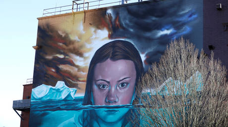 A man looks over the side of a building where a mural of Greta Thunberg has been painted, in Bristol, Britain, February 27, 2020. File photo: © REUTERS/Peter Nicholls
