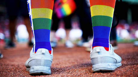 FILE PHOTO: A fan wears rainbow colored socks for Pride Night before a game between the Boston Red Sox and the Detroit Tigers at Fenway Park on June 9, 2017 in Boston, Massachusetts.