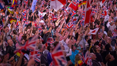 People wave flags during the last night of the Proms at The Royal Albert Hall in 2015.  © AFP / JUSTIN TALLIS