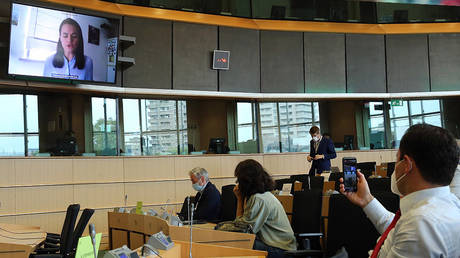 Members of the Committee on Foreign Affairs of the European Parliament attend a video-conference meeting with Belarusian opposition figurehead Svetlana Tikhanovskaya (on screen) on the political situation in Belarus at the European Parliament in Brussels on August 25, 2020