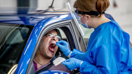 A health worker taking samples from a person suspected to be infected with the coronavirus during the tests ©LightRocket via Getty Images/SOPA Images/Robin Utrecht