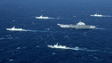 FILE PHOTO: China's Liaoning aircraft carrier with accompanying fleet conducts a drill in an area of South China Sea in this undated photo taken December, 2016