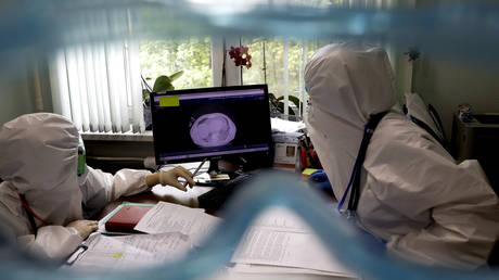 FILE PHOTO: Health officials check tomography datas displaying Covid-19 symptoms on lungs and the overall damage of the virus to the body received with radiological testing method at a state hospital in Moscow, Russia on May 22, 2020