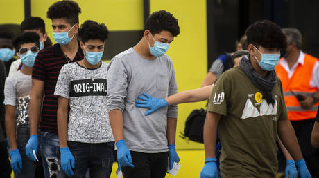 FILE PHOTO. Unaccompanied underage refugees board a plane at the Eleftherios Venizelos International Airport in Athens on July 7, 2020.