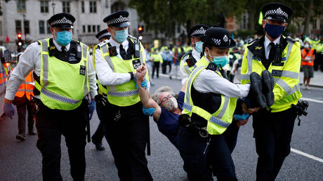 Police officers detain a protester during a "peaceful disruption" of Parliament as lawmakers return from the summer recess, at Parliament Square in London, Britain, September 1, 2020.