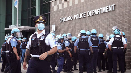 FILE PHOTO: Chicago police stand guard as demonstrators protest outside the department's 7th District station on August 11, 2020 in Chicago, Illinois