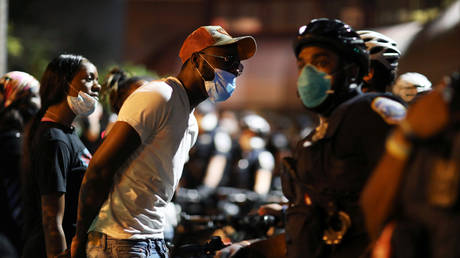 Protesters gather at the DC police's 7th precinct to express anger after officers shot and killed a young black man in Washington, DC September 2, 2020.