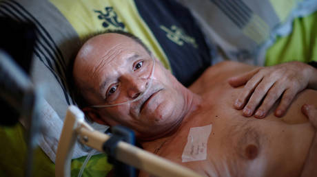 Alain Cocq, 57, in his medical bed he has been confined to for years as a result of a degenerative disease that has no treatment, poses after an interview with Reuters at his home in Dijon, France, August 19, 2020.