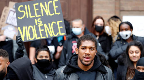Boxer Anthony Joshua is seen with protestors during a Black Lives Matter protest in Watford, following the death of George Floyd who died in police custody in Minneapolis, Watford, Britain, June 6, 2020. © REUTERS/Paul Childs