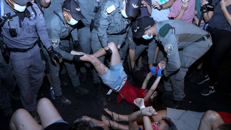 Police officers detain a protester during a demonstration against Israeli PM Benjamin Netanyahu in Jerusalem, September 6, 2020