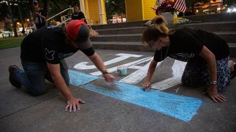 Patriot Prayer activist Aaron “Jay” Danielson was honored at a memorial Saturday calling for peace, but violence returned a short time later as a supporter was allegedly hit purposely by a truck driven by an Antifa member.