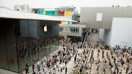 People observe social distancing as they wait for the opening of the new Apple flagship store following an outbreak of COVID-19 in Beijing, China