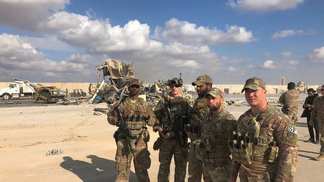 U.S. Soldiers stand at a site of Iranian bombing at Ain al-Asad air base in Anbar, Iraq, Monday, Jan. 13, © AP Photo/Qassim Abdul-Zahra