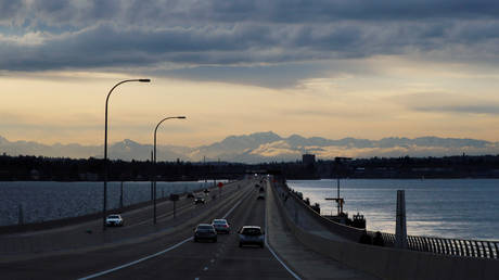 A few cars drive on a nearly empty highway on the road in to Seattle, Washington, US