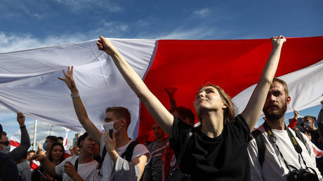 Opposition supporters carry a historical white-red-white flag of Belarus as they take part in a rally against police brutality following protests to reject the presidential election results in Minsk, Belarus September 13, 2020.