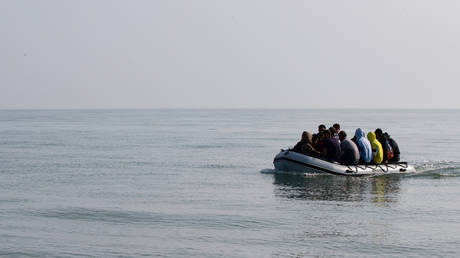 Migrants land on Deal beach after crossing the English channel from France in a dinghy on September 14, 2020 in Deal, England