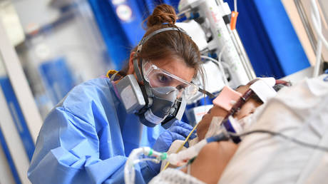 FILE PHOTO: Clinical staff wear Personal Protective Equipment (PPE) as they care for a patient at the Intensive Care unit at Royal Papworth Hospital on May 5, 2020 in Cambridge, England.