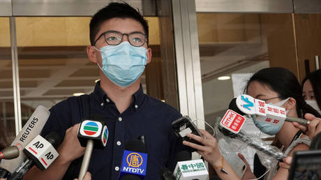Pro-democracy activist Joshua Wong speaks to the media at the High Court in Hong Kong