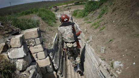 FILE PHOTO. Soldiers walk in a trench at their position near Nagorno-Karabakh's boundary. ©REUTERS