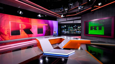 FILE PHOTO: A picture taken on June 8, 2018 shows an unidentified anchor of the Russia Today (RT) TV company as he prepares to go on the air in their studio in Moscow.