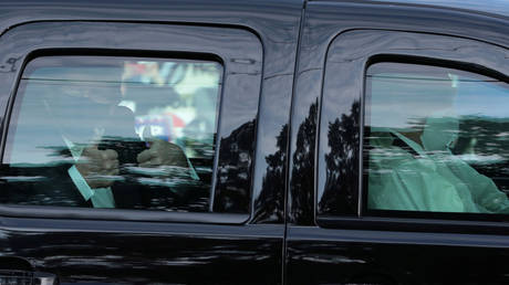 US President Donald Trump rides in front of the Walter Reed National Military Medical Center in Bethesda, Maryland, US, October 4, 2020