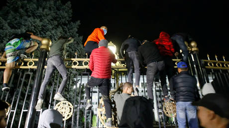 Protesters try to break into the government headquarters during a rally against the result of a parliamentary election in Bishkek, Kyrgyzstan