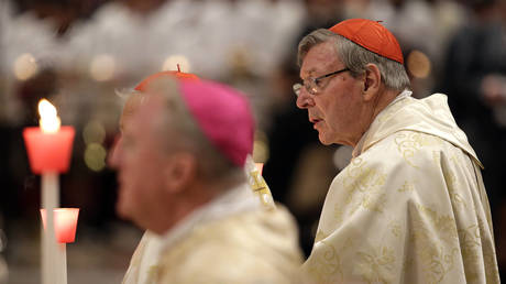 FILE PHOTO: Australian Cardinal George Pell holds a candle as Pope Francis leads the Easter vigil mass in Saint Peter's basilica at the Vatican, April 15, 2017