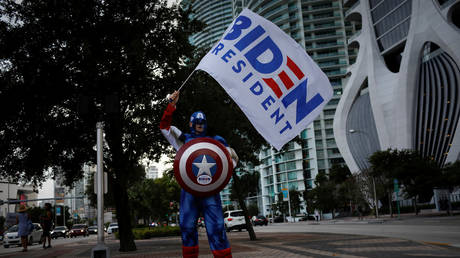 A supporter of Democratic U.S. presidential nominee Joe Biden wears a Captain America costume during a gathering outside Perez Art Museum before his arrival for a town hall event in Miami, Florida, U.S., October 5, 2020