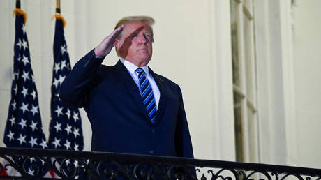 U.S. President Donald Trump salutes as he poses without a face mask on the Truman Balcony of the White House after returning from being hospitalized at Walter Reed Medical Center for coronavirus disease (COVID-19) treatment, in Washington, U.S. October 5, 2020.
