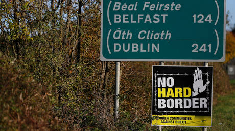 A 'No hard Border' poster is seen below a road sign on the Irish side of the border between Ireland and Northern Ireland near Bridgend. © Reuters / Phil Noble