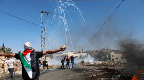 Palestinian demonstrators run away from tear gas fired by Israeli forces during a protest against Jewish settlements, in Kafr Qaddum in the Israeli-occupied West Bank, October 2, 2020. © Reuters / Mohamad Torokman