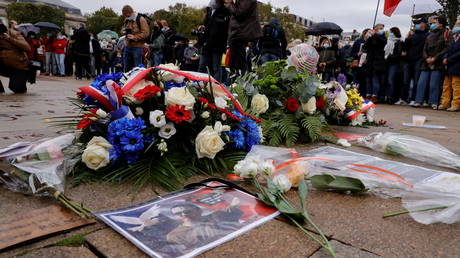 Floral tributes to Samuel Paty, the French teacher who was beheaded on the streets of a Paris suburb, are seen at the Place de la Republique, in Lille, France, October 18, 2020. © Reuters / Pascal Rossignol