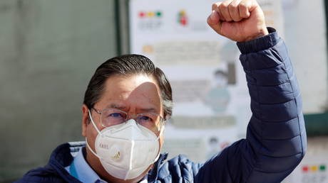 Luis Arce, Presidential candidate of the Movement to Socialism party (MAS), raises his fist after voting at a polling station during Bolivia's presidential election in La Paz, Bolivia, October 18, 2020.
