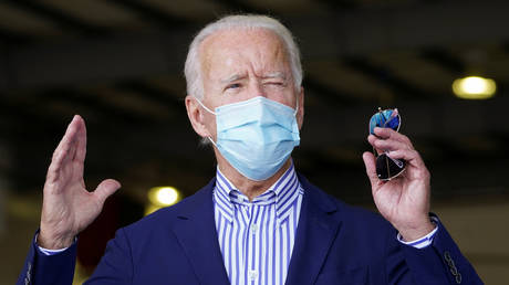 Democratic U.S. presidential nominee Joe Biden speaks to reporters in a hangar after he and Democratic U.S. vice presidential nominee Kamala Harris arrived at Phoenix Sky Harbor International Airport in Phoenix, Arizona, U.S., October 8, 2020