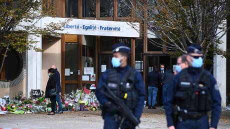 Police stand outside Samuel Paty's school in Conflans-Sainte-Honorine, France October 19, 2020