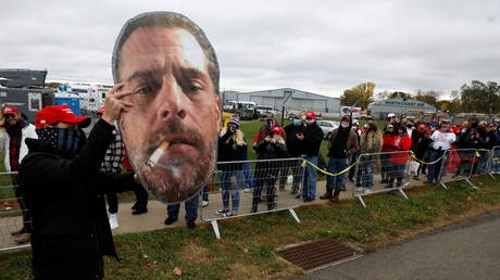 A supporter of US President Donald Trump holds up a photo of Hunter Biden before Trump's campaign event in Erie, Pennsylvania, U.S. October 20, 2020