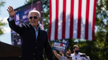 Democratic presidential nominee and former Vice President Joe Biden waves to sympathizers at the end of his speech at the Riverside High School in Durham, North Carolina during a campaign stop on October 18, 2020.