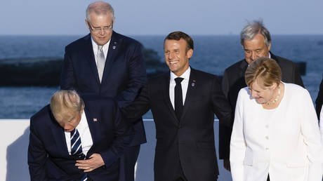 FILE PHOTO: Donald Trump, Emmanuel Macron and Angela Merkel as G7 leaders and guests gather for a family picture in front of the Biarritz lighthouse on the second day of the annual G7 summit on August 25, 2019 in Biarritz, France.
