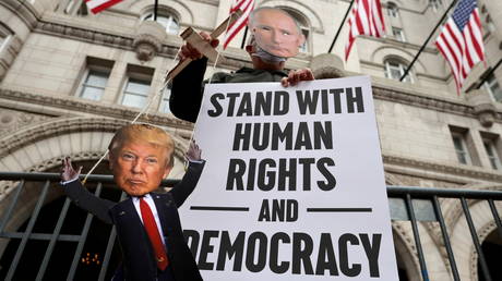 US President Donald Trump depicted as puppet of Russian President Vladimir Putin by a protester outside the Trump International Hotel in Washington, October 27, 2020.