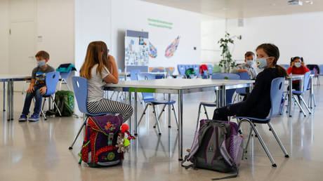 FILE PHOTO: Children sit in a waiting room at a primary school in Brunn am Gebirge, Austria.