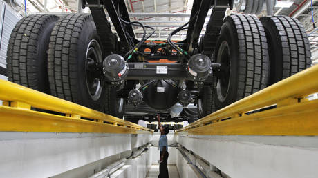 An employee inspects the engine of a BharatBenz truck inside Daimler's new factory in Oragadam in the Kancheepuram district of the southern Indian state of Tamil © Reuters