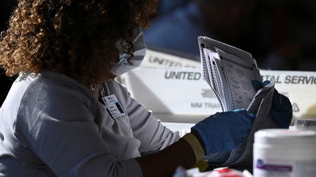 An employee of the Fulton County Board of Registration and Elections processes ballots in Atlanta, Georgia, November 4, 2020.