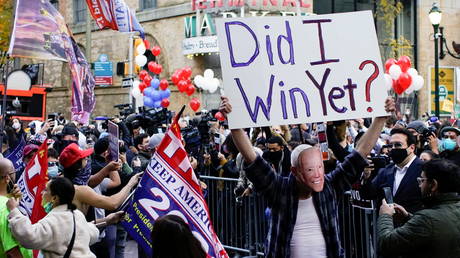 Trump supporter is wearing a Joe Biden mask at a rally as votes continue to be counted following the 2020 U.S. presidential election, in Philadelphia