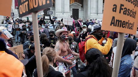 Trump supporter Robert Burck, also known as Naked Cowboy, is confronted by protesters during a "Count Every Vote" rally the day after the U.S. election in the Manhattan borough of New York City, New York, U.S., November 4, 2020