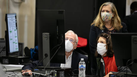 Members of an adjudication review panel look over scanned absentee ballots at the Fulton County Election Preparation Center on November 4, 2020 in Atlanta, Georgia.