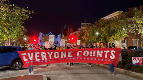 FILE PHOTO: Activists march along State Street in front of the Pennsylvania State Capitol Building to protest attempts to halt the counting of ballots cast in the state for the 2020 presidential election, in Harrisburg, Pennsylvania November 4, 2020