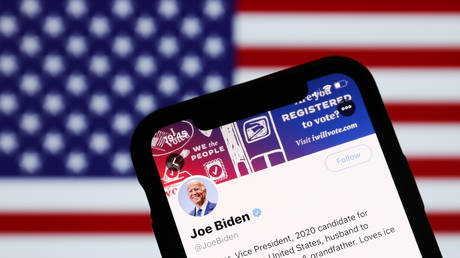 FILE PHOTO: Twitter feed of candidate for President of the USA Joe Biden is seen displayed on a phone screen with American flag in the background in this illustration photo taken on October 18, 2020