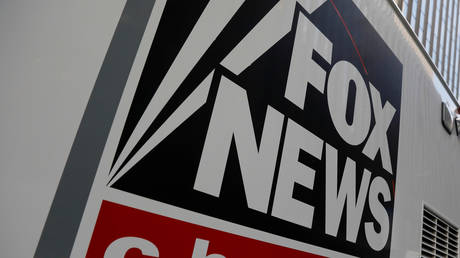 A Fox News channel sign is seen on a television vehicle outside the News Corporation building in New York City