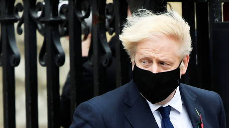 Britain's Prime Minister Boris Johnson wearing a face mask leaves the Westminster Abbey following a remembrance service on Armistice Day in London, Britain, November 11, 2020